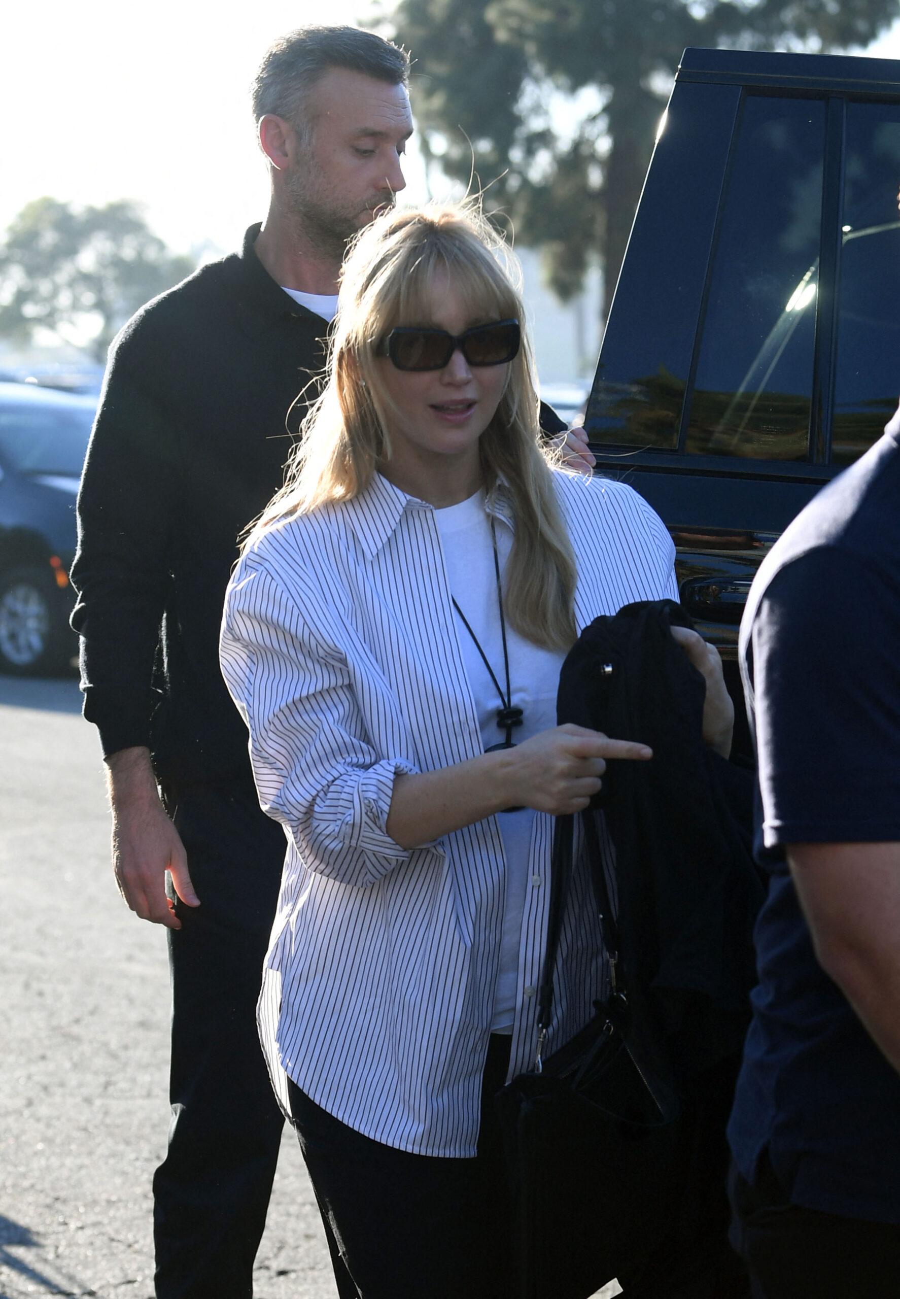 Jennifer Lawrence shows off her baby bump with her husband Cooke Maloney at the World Series in L.A.