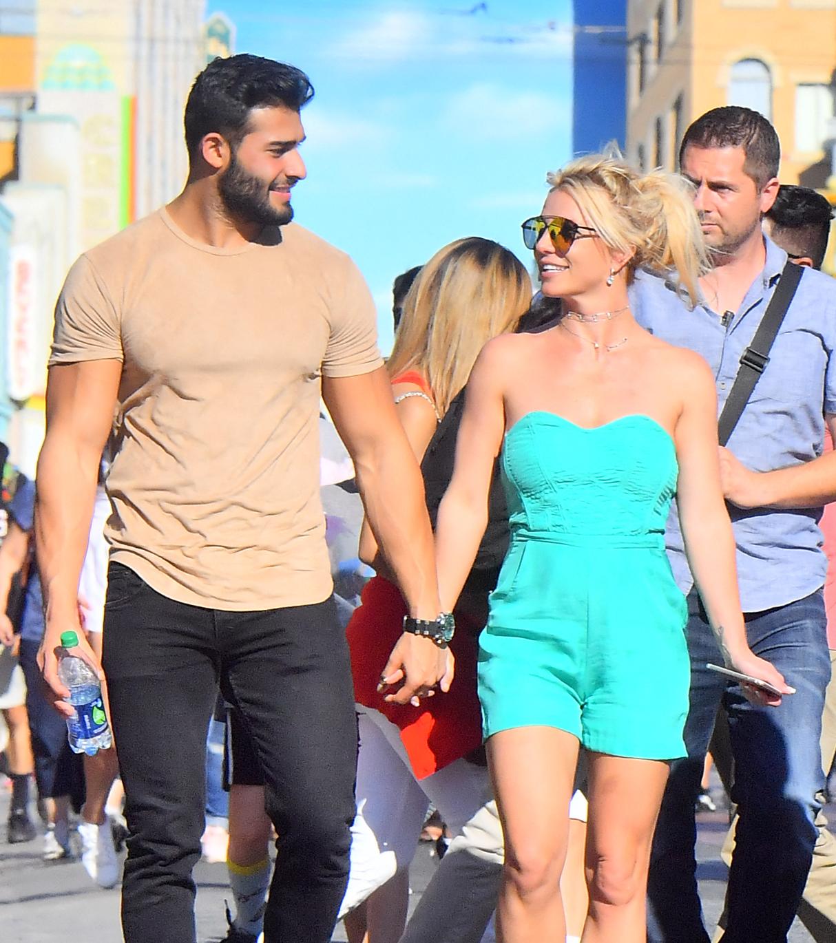 EXCLUSIVE: Britney Spears and her boyfriend Sam Asghari hold hands while out celebrating her son's birthday at Disneyland
