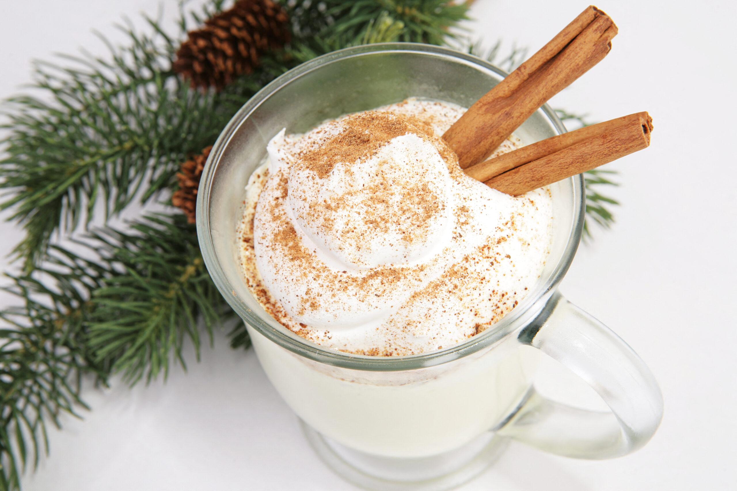 Delicious Christmas eggnog, with whipped cream, nutmeg and cinnamon.