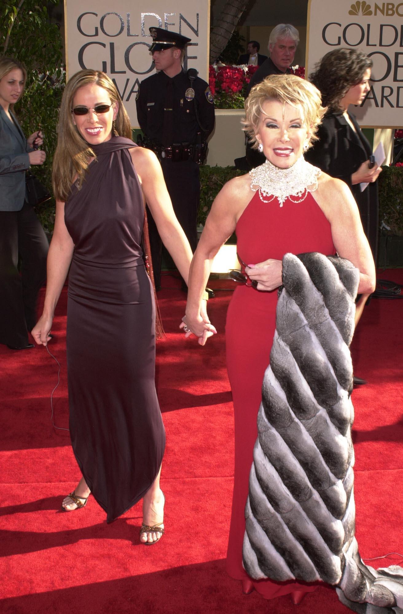 Melissa Rivers and her mom Joan Rivers holding hands at the Golden Globe