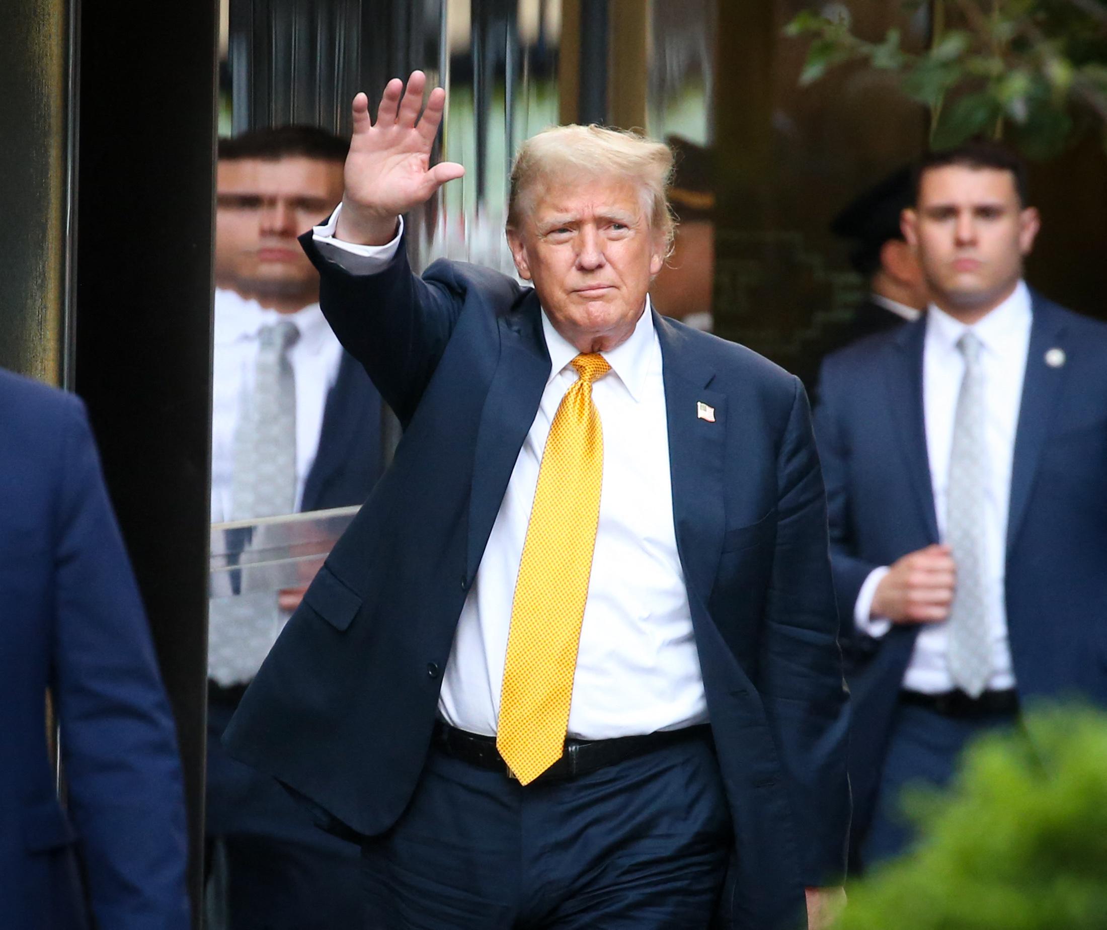 Donald Trump comes right up to the barriers at Trump Tower to wave to all the crowds that have waited to see him as he arrives after a Jurors deliberated at court