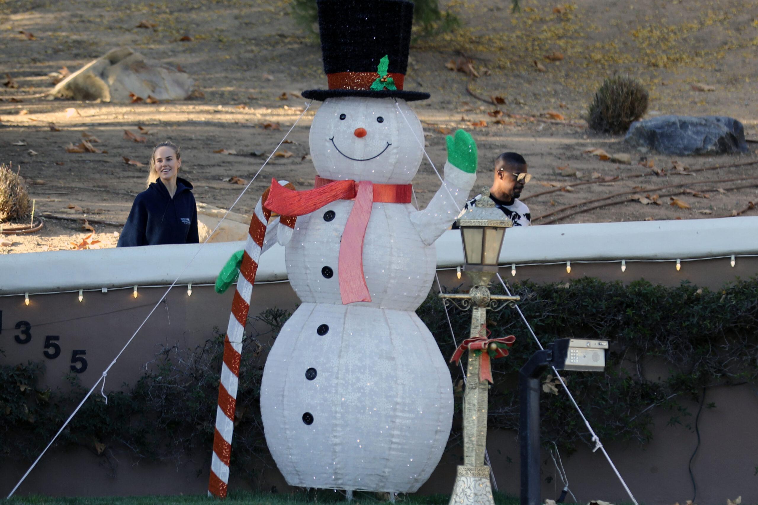 Actor Jamie Foxx is seen with his girlfriend Alyce Huckstepp taking their three dogs for a walk around his property which has been turned into a winter wonderland. 