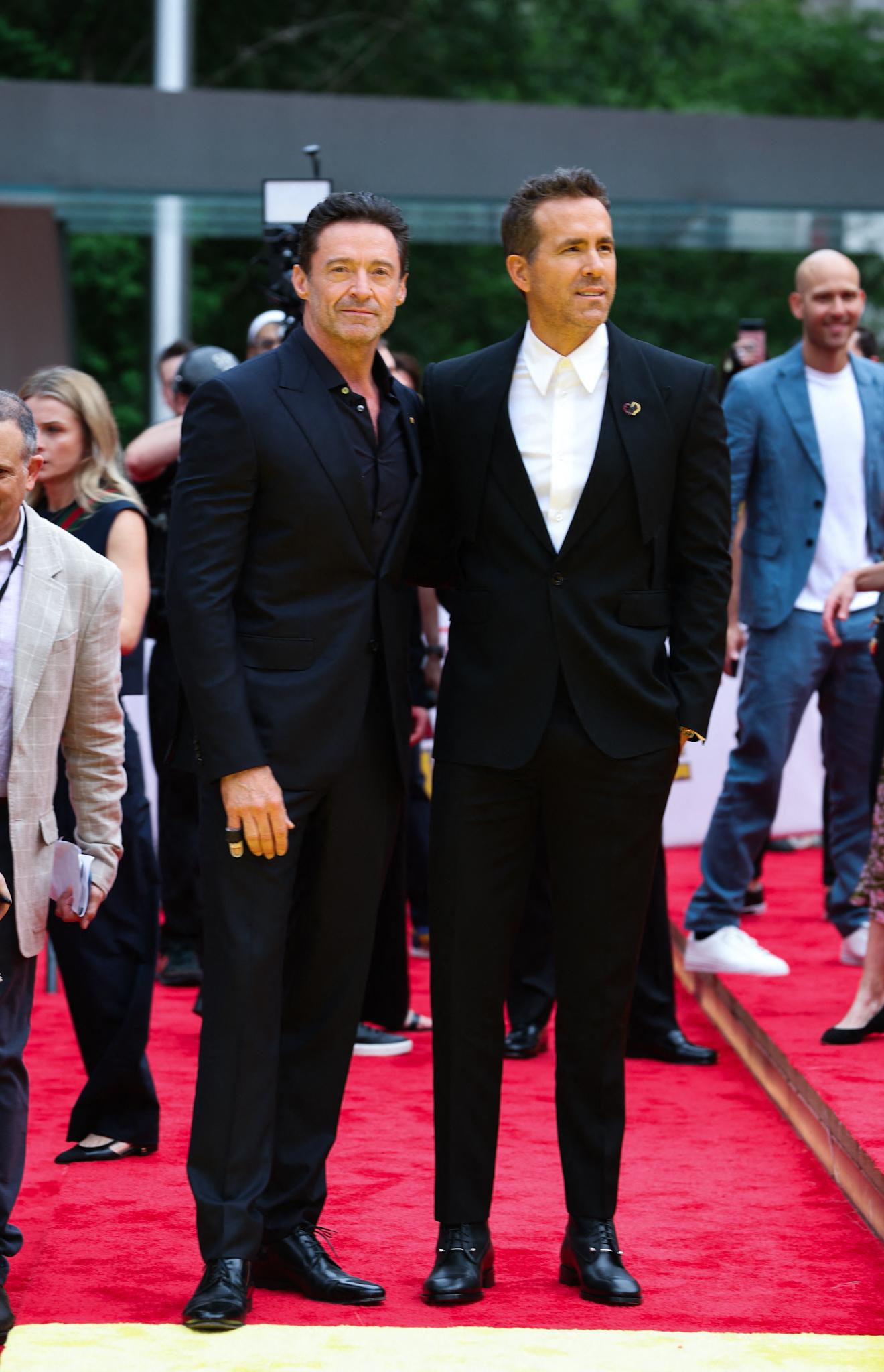 Hugh Jackman and Ryan Reynolds seen posing together alongside director Shawn Levy on the red carpet premiere for Deadpool and Wolverine tonight in New York City