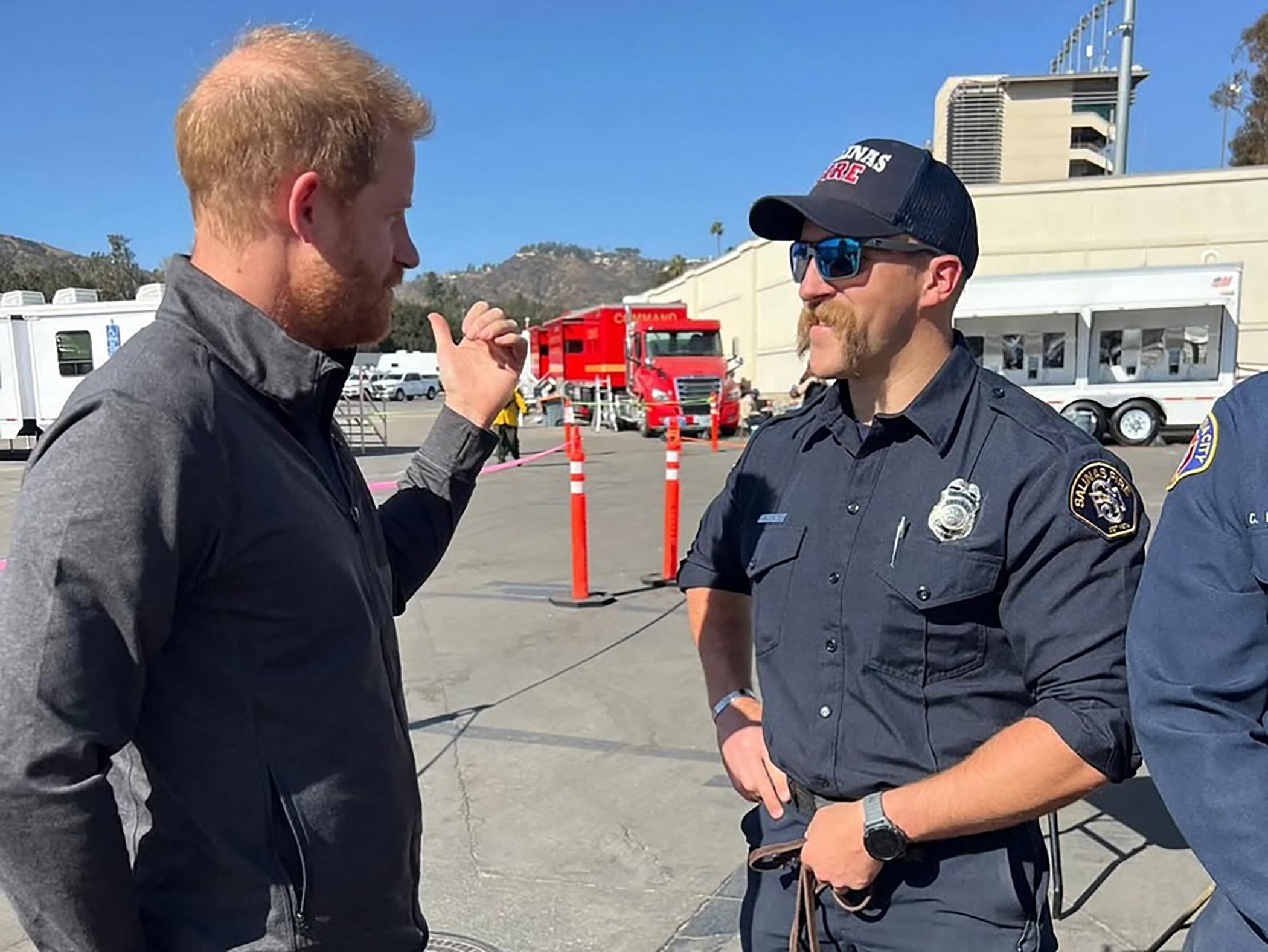 Prince Harry poses with LA fire department and therapy dogs amid California wildfire relief efforts.