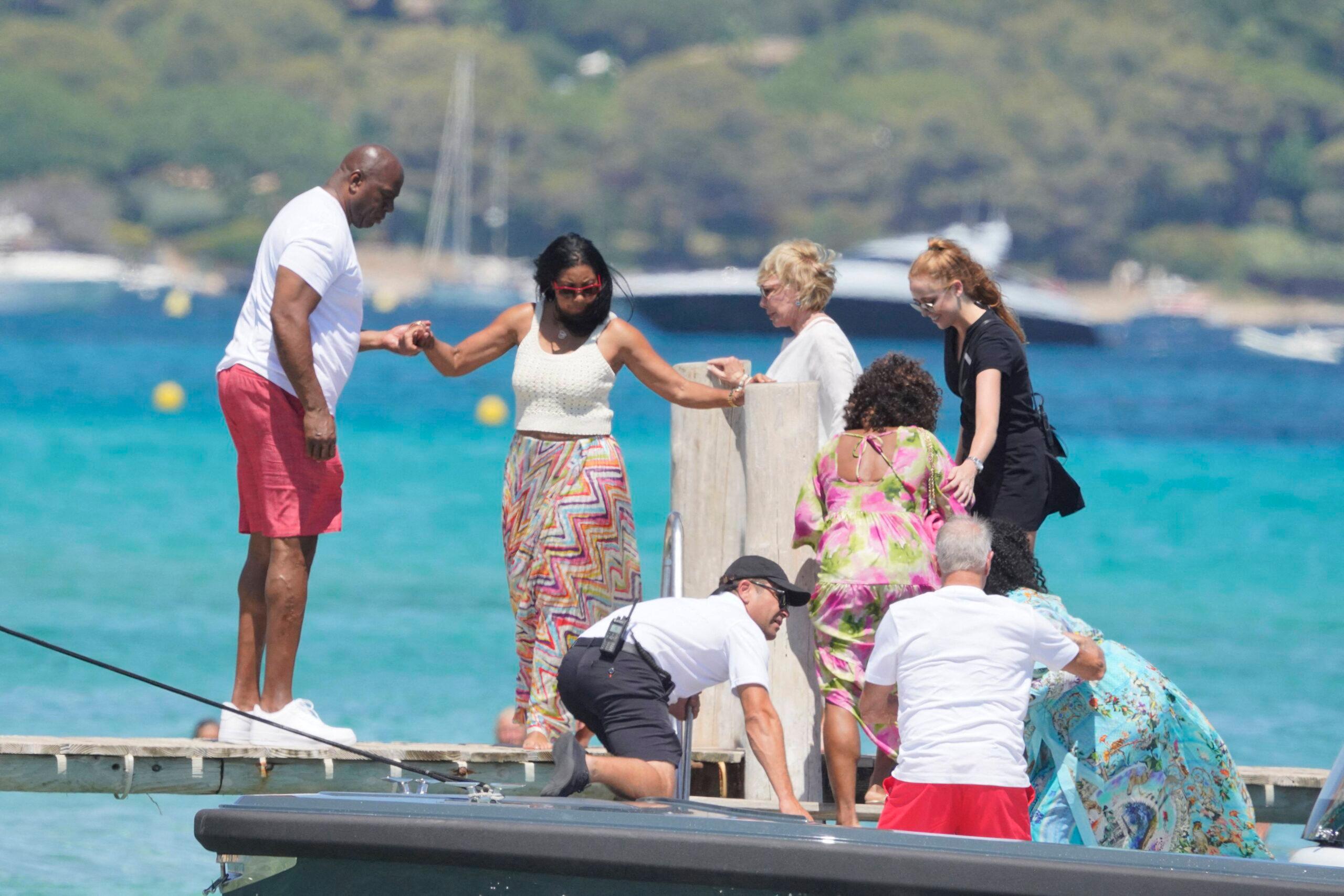 Magic Johnson, his family and friends arrive at Club 55 while on vacation in St-Tropez. 