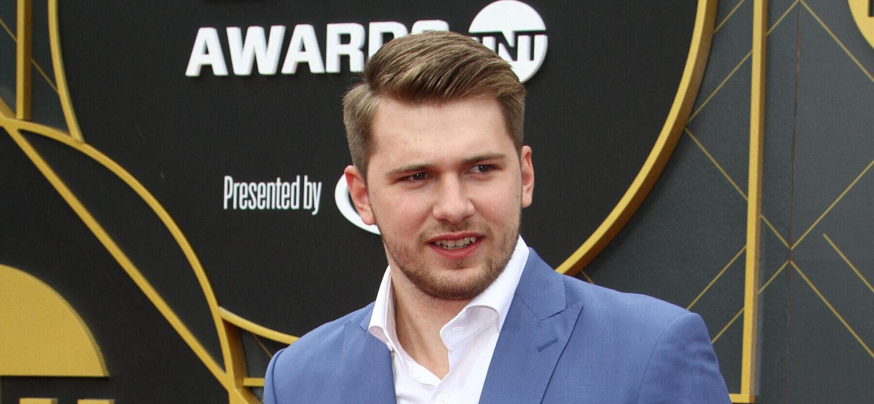 Luka Doncic smiling on the red carpet.