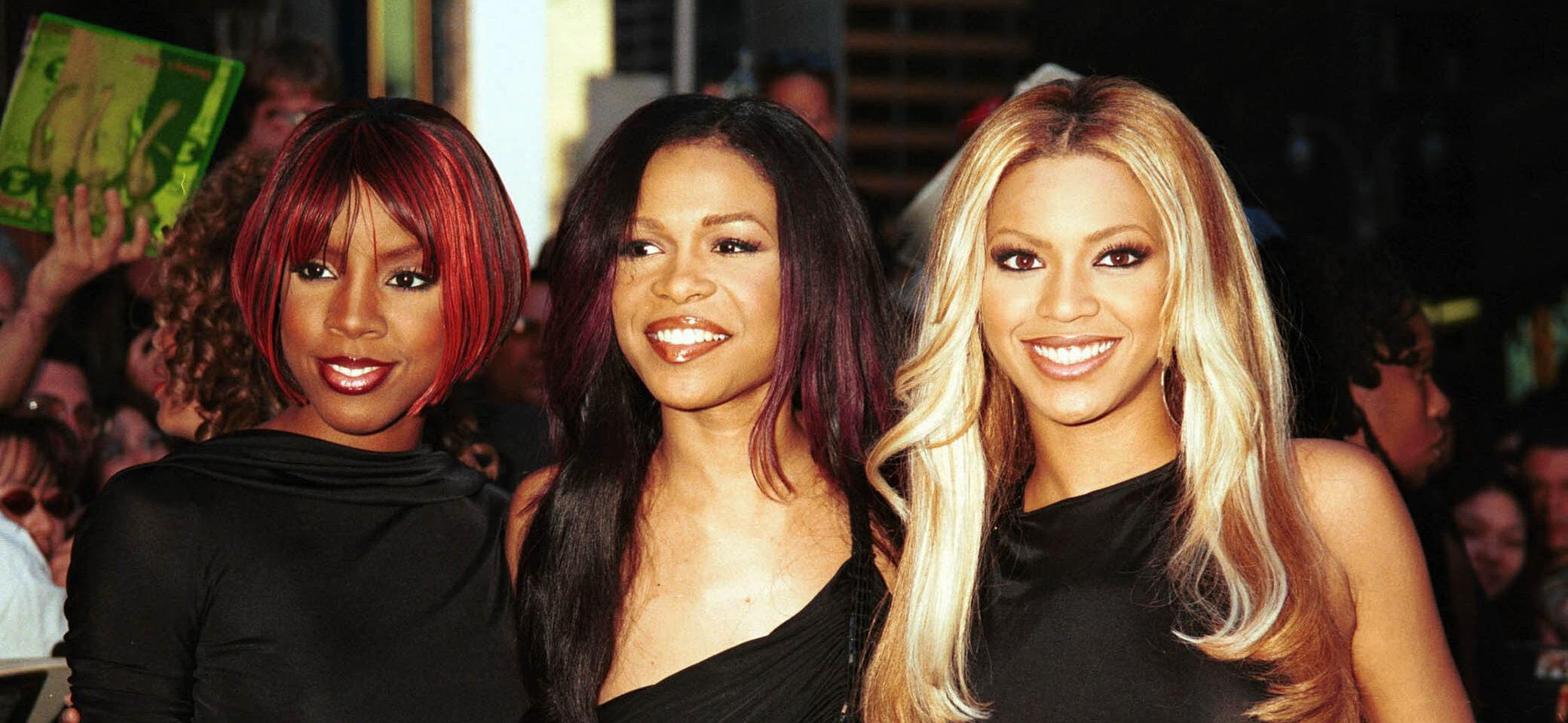 Destiny's Child posing in all black for a group photo in 2001.