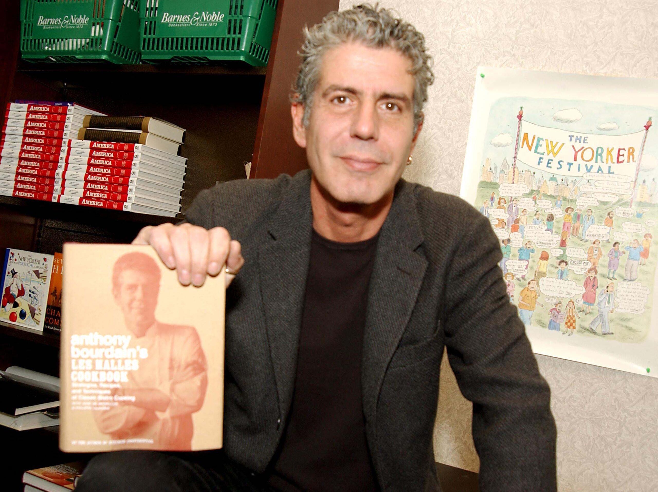 Anthony Bourdain holding a book