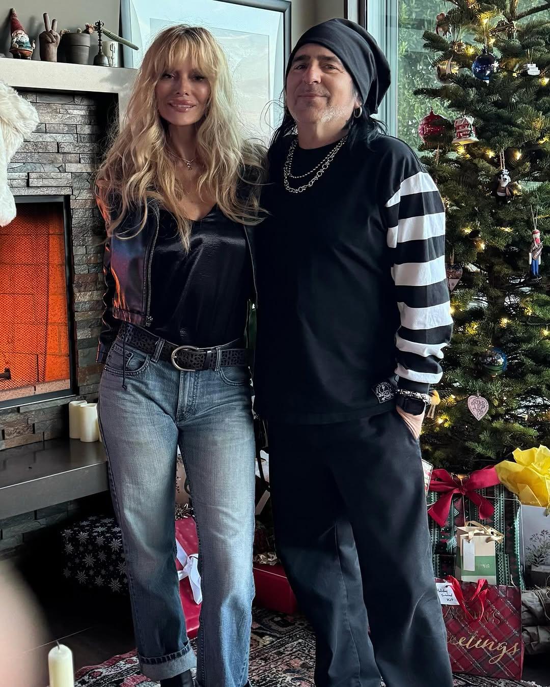 Taime Downe and Kimberly Burch in front of a Christmas tree