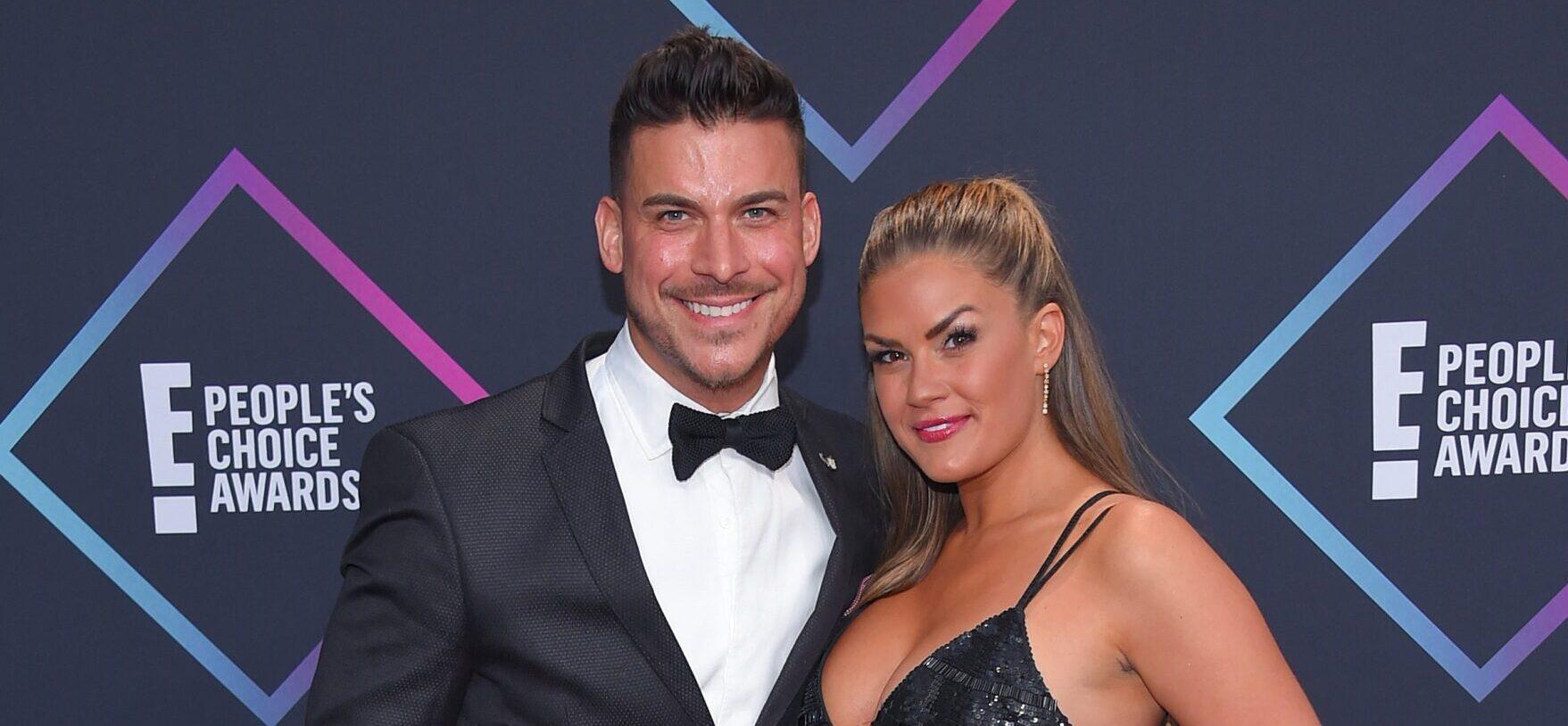 Brittany Cartwright and Jax Taylor posing together on the red carpet.