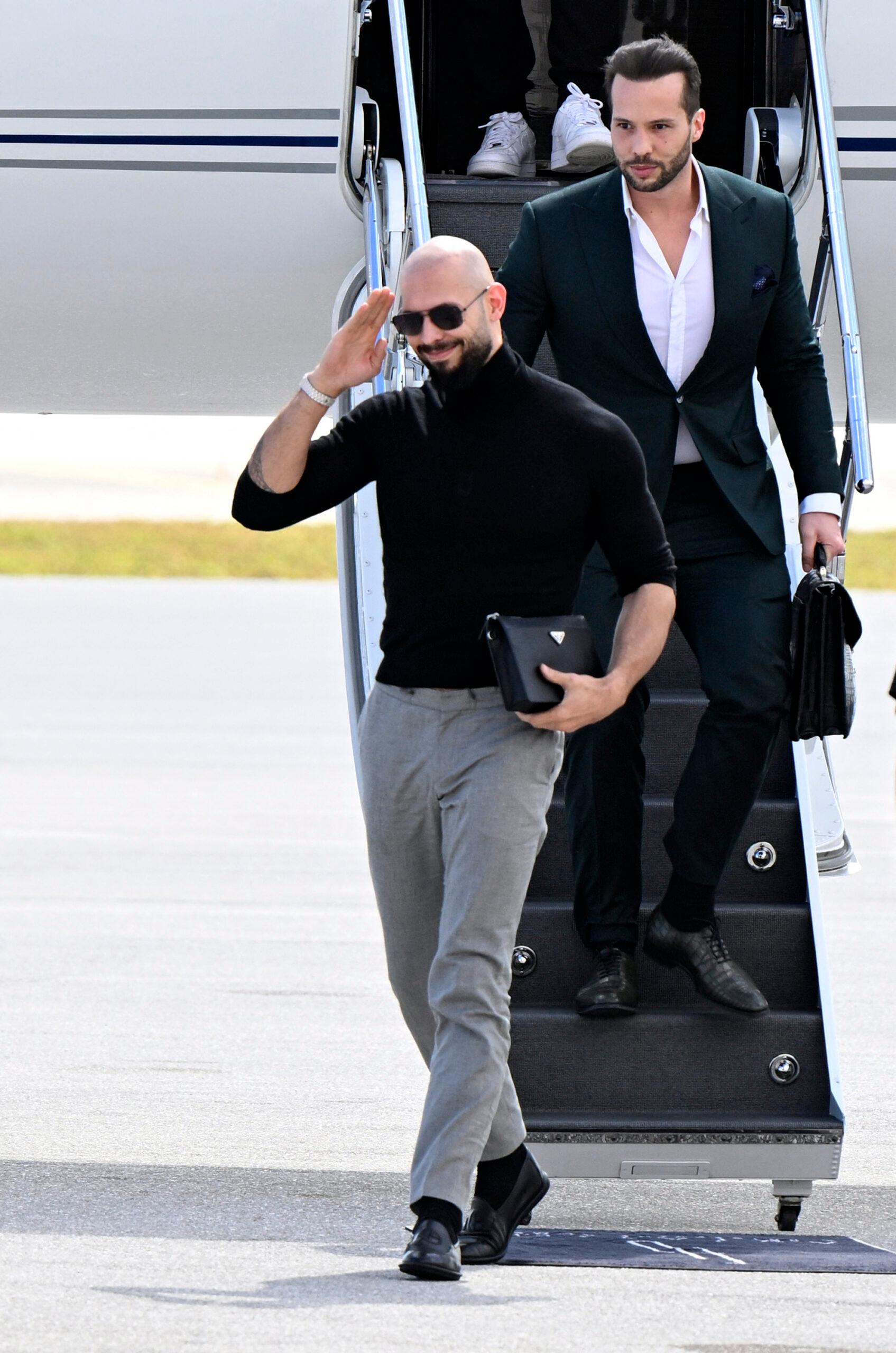 Andrew and Tristan Tate stepping off of a plane in the state of Florida. 