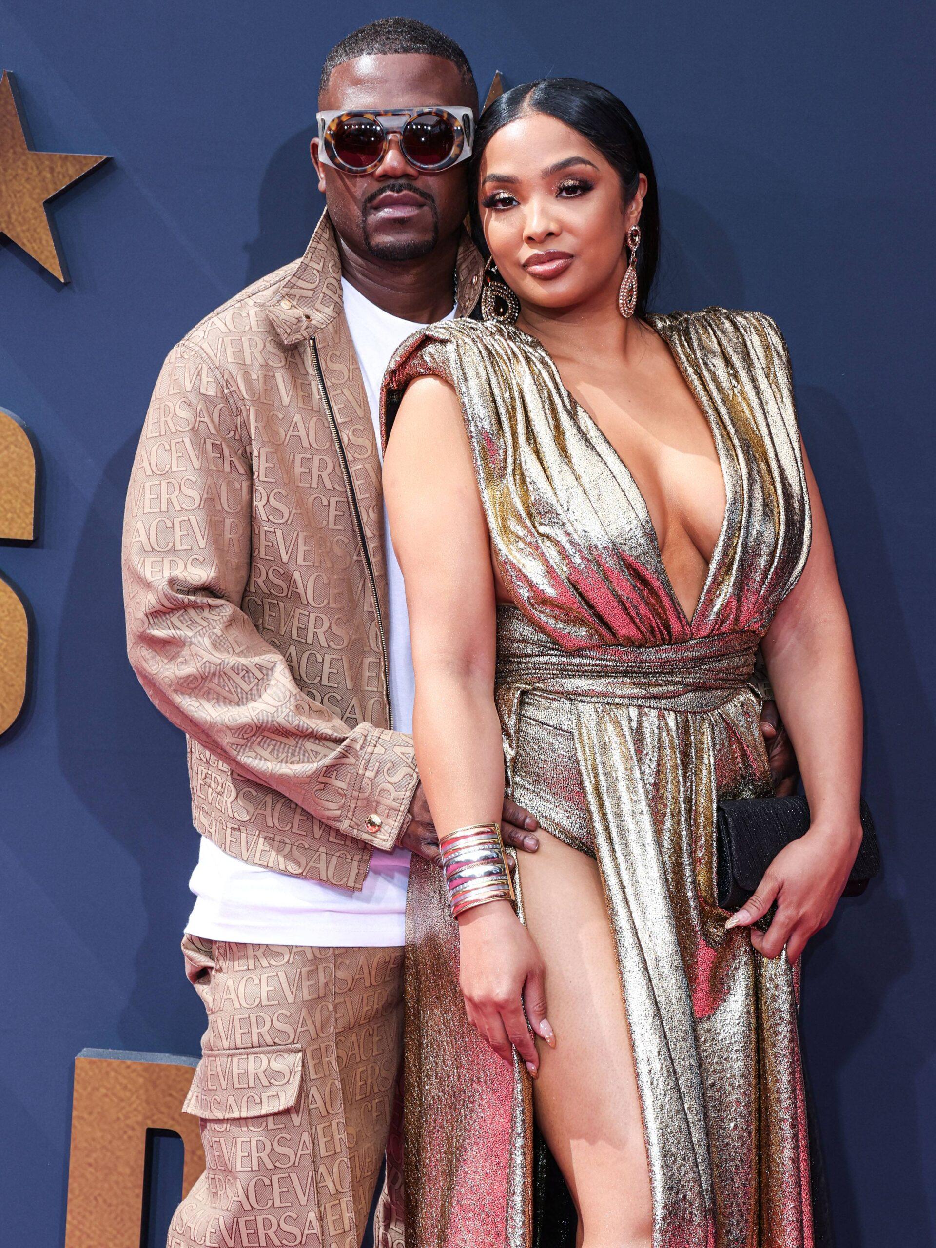 Ray J posing with Princess Love on the red carpet at the BET Awards.