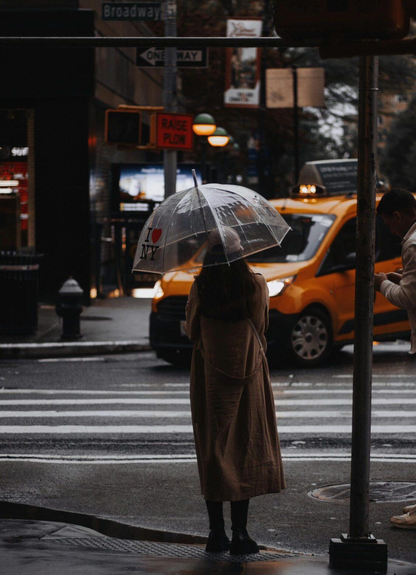 Woman with umbrella standing on the street of New York