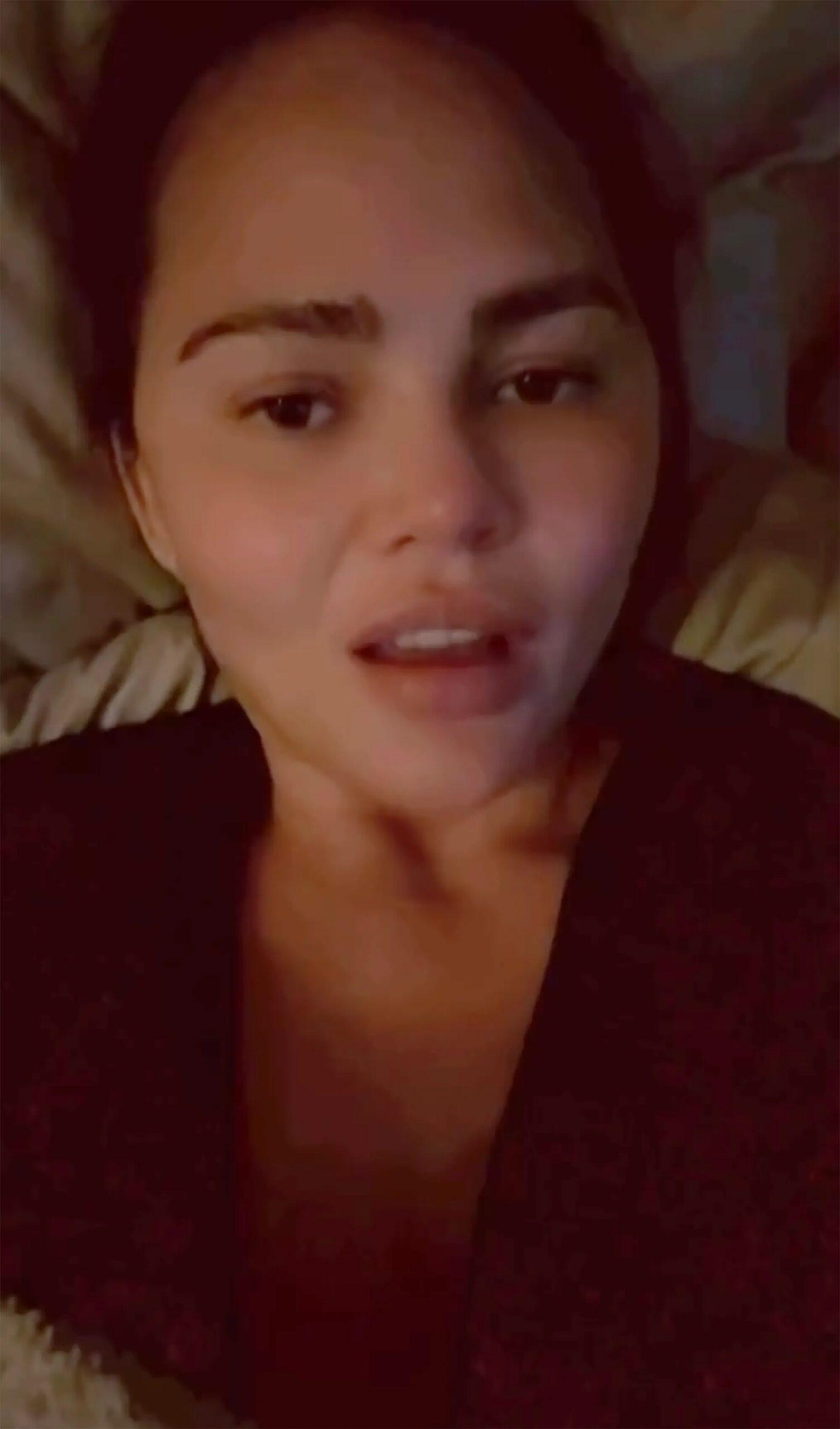 Chrissy Teigen lying in bed