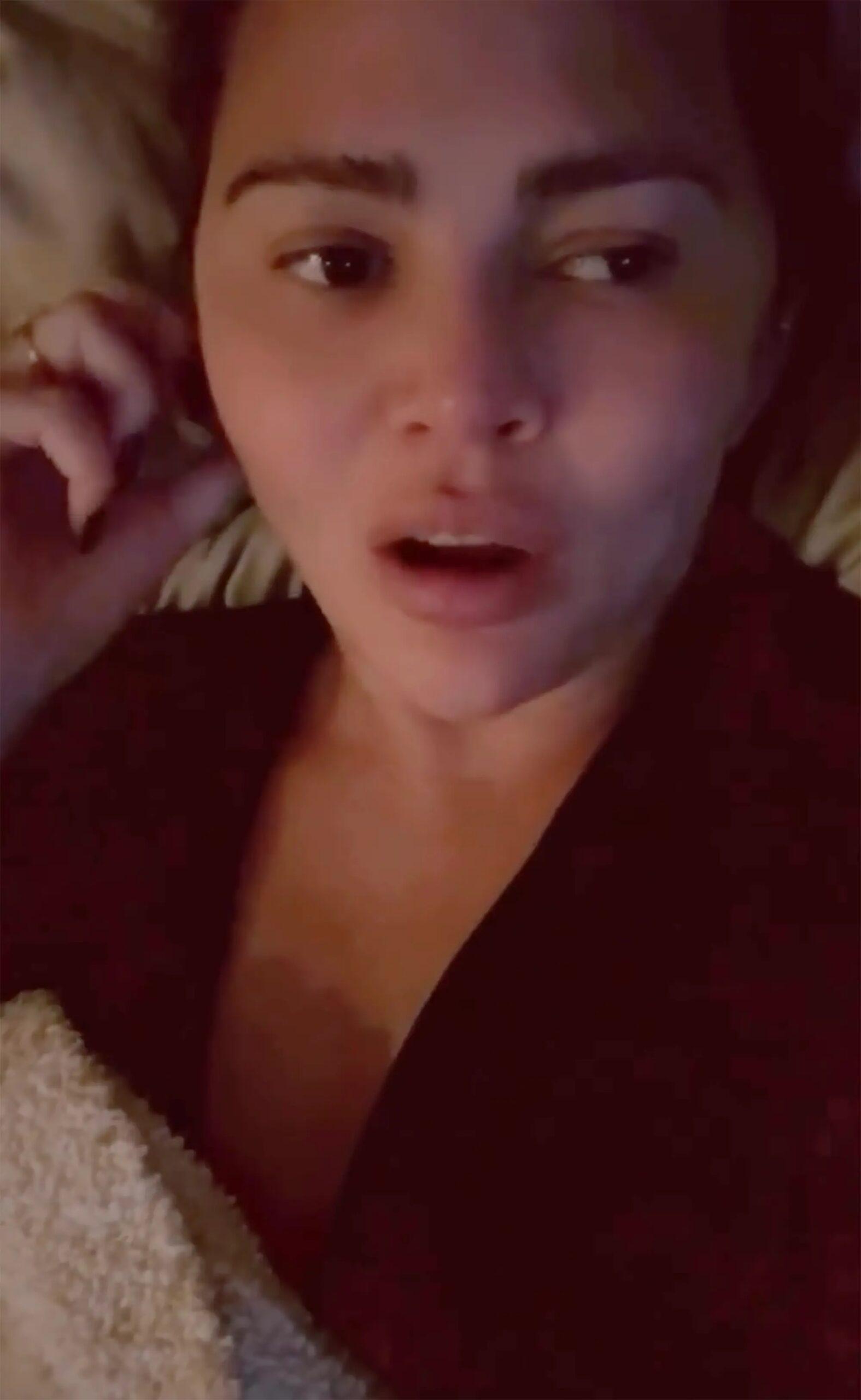 Chrissy Teigen lying in bed