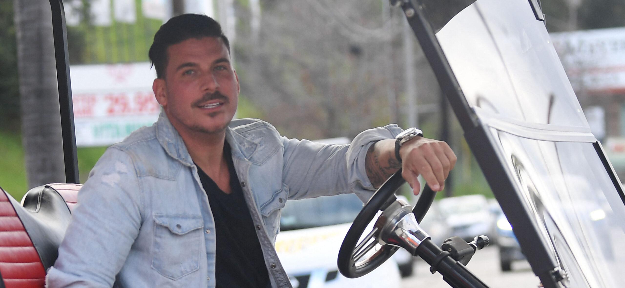 Jax Taylor looking into the camera on a golf cart.