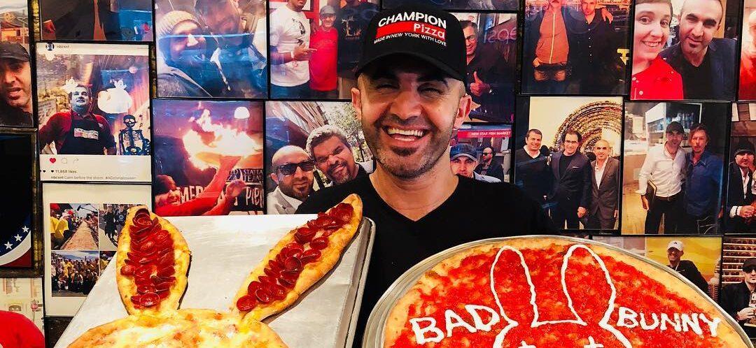 Hakki Akdeniz holding pizza