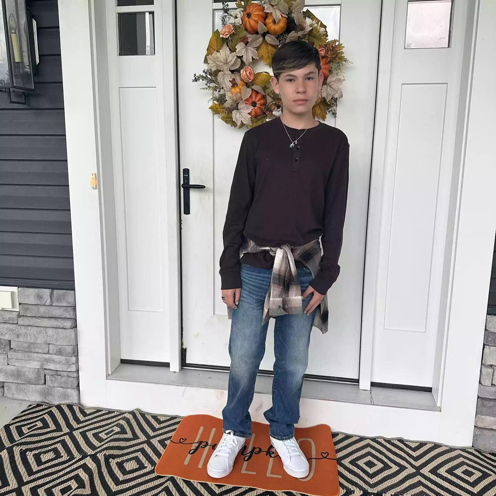 Elliot Lowry standing in front of a door