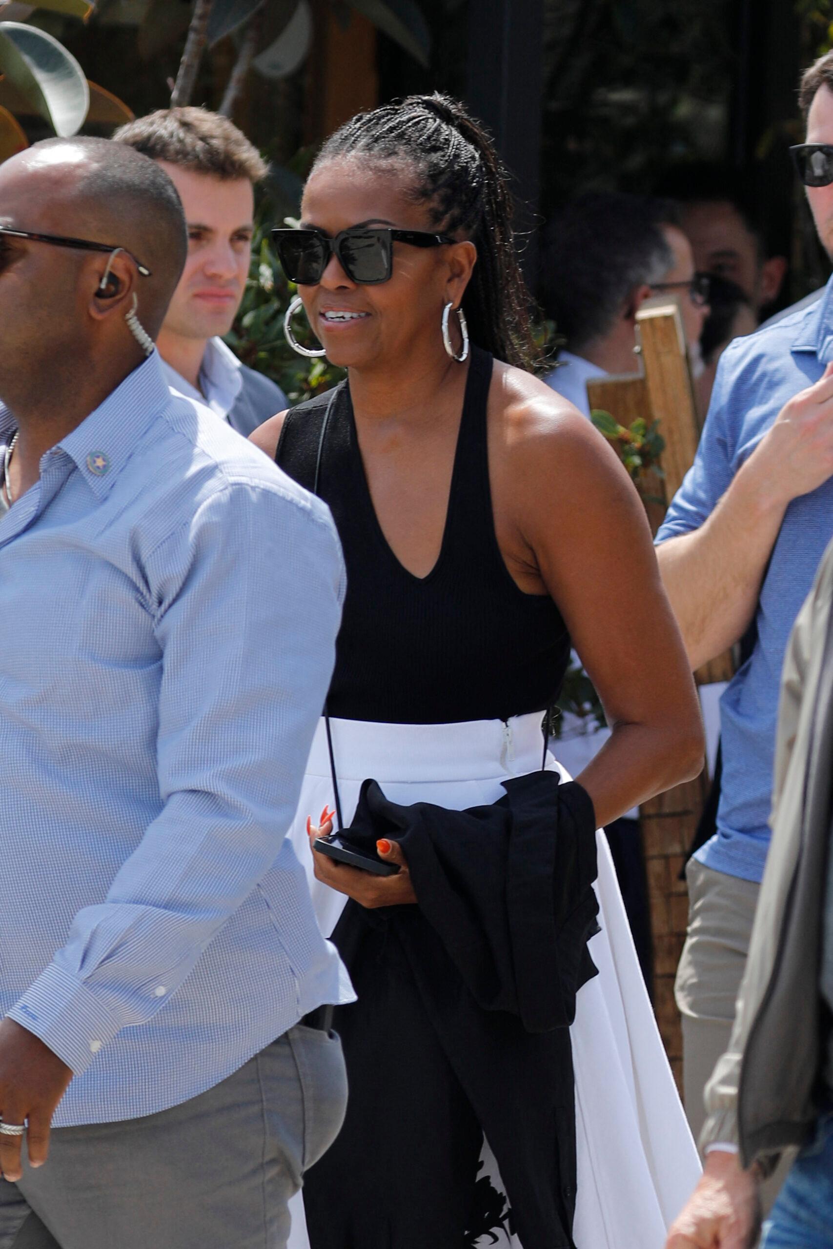 Barack Obama and Michelle Obama walk through Barcelona after visiting the Moco museum and eat with the Spielberg`s.