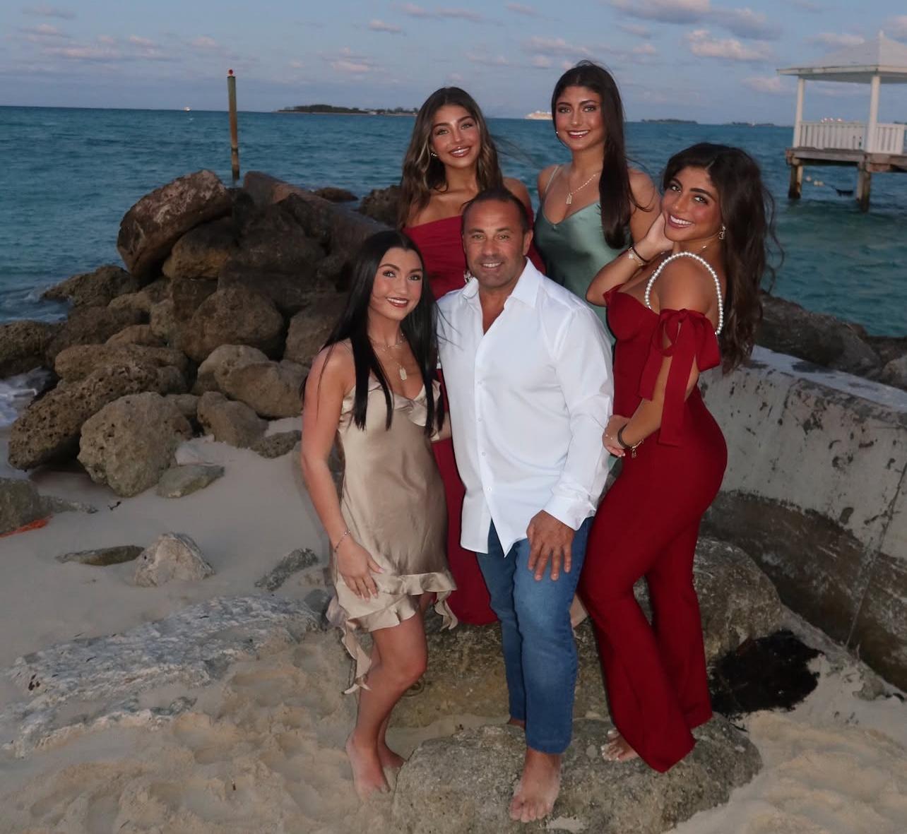 Joe Giudice and his daughters posing on a beach