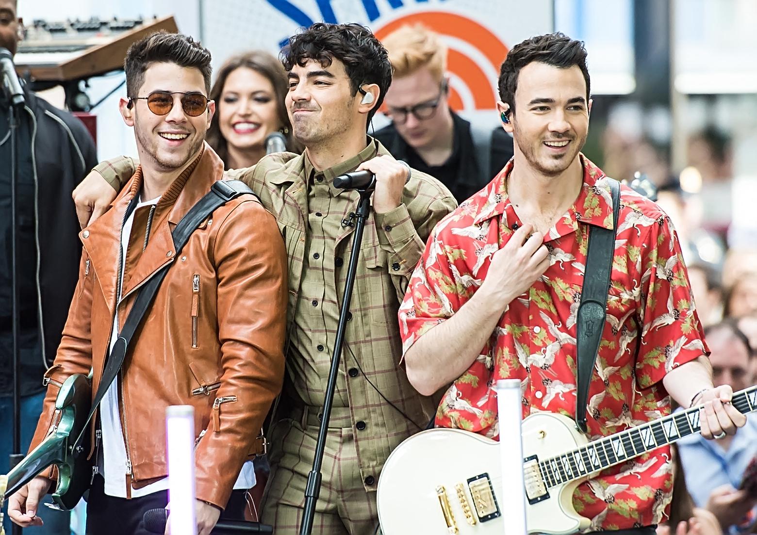 Joe Jonas, Nick Jonas, and Kevin Jonas performing