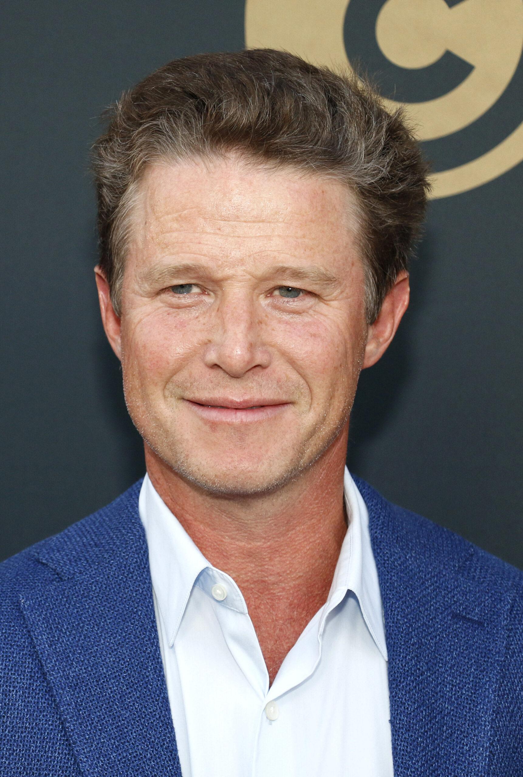 Billy Bush posing on the red carpet. 