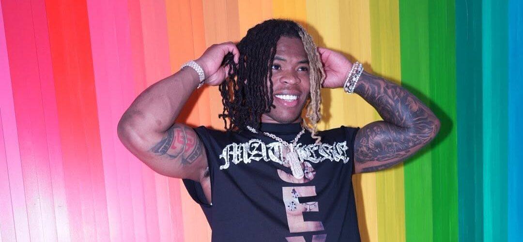 Quinshon Judkins posing in front of a colorful wall.