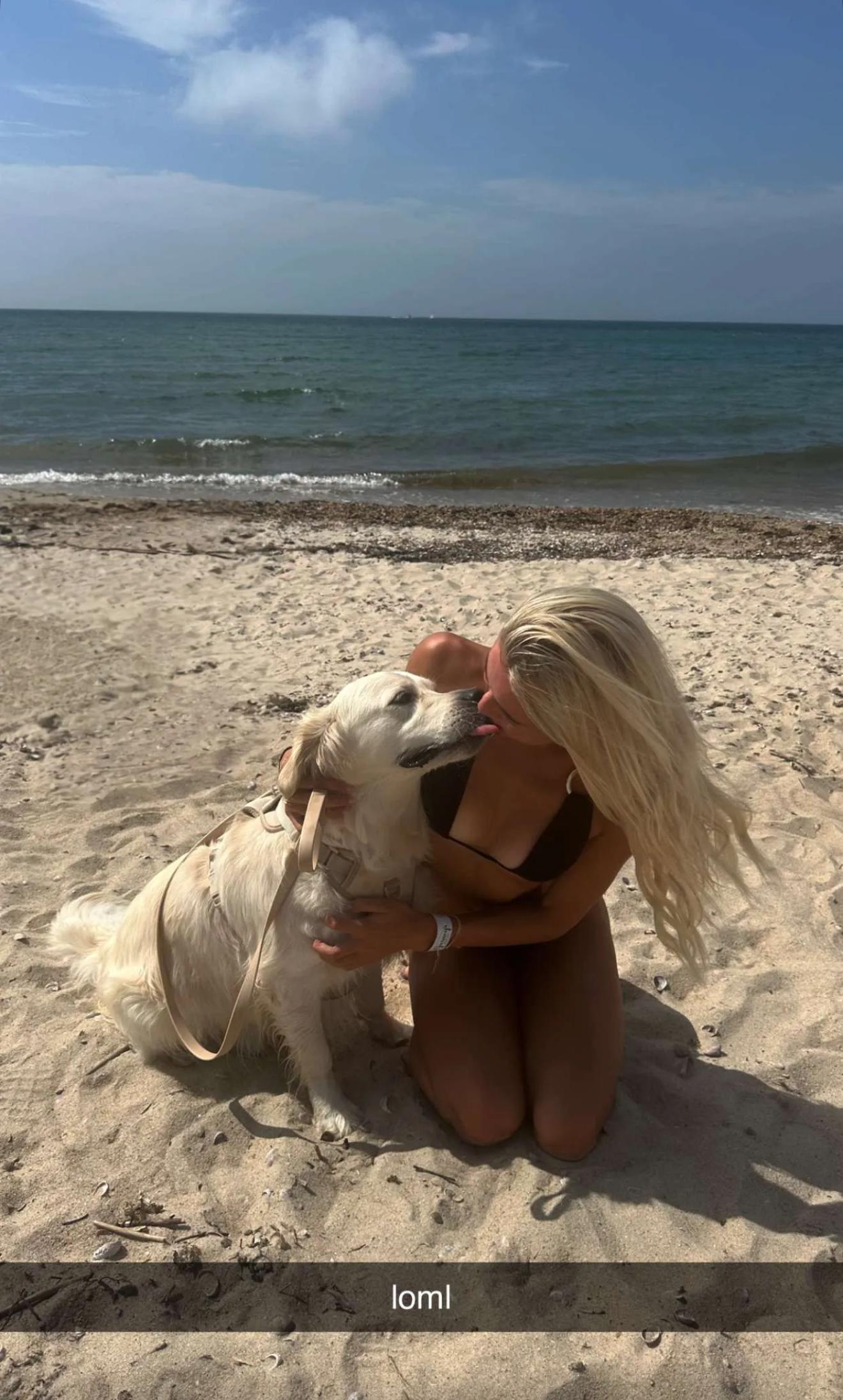 Olivia Dunne poses with her dog.