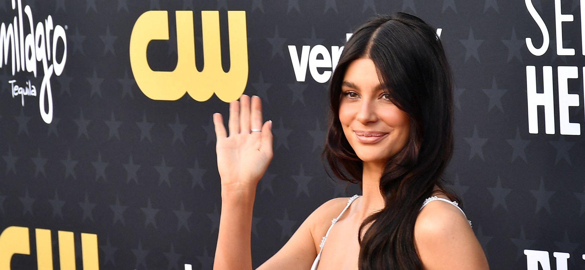 Camila Morrone waving