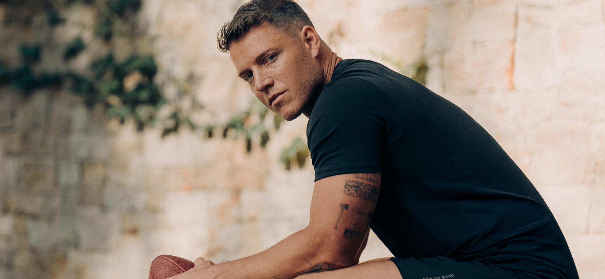 Christian McCaffrey holding a football