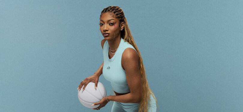 Angel Reese posing with a basketball.