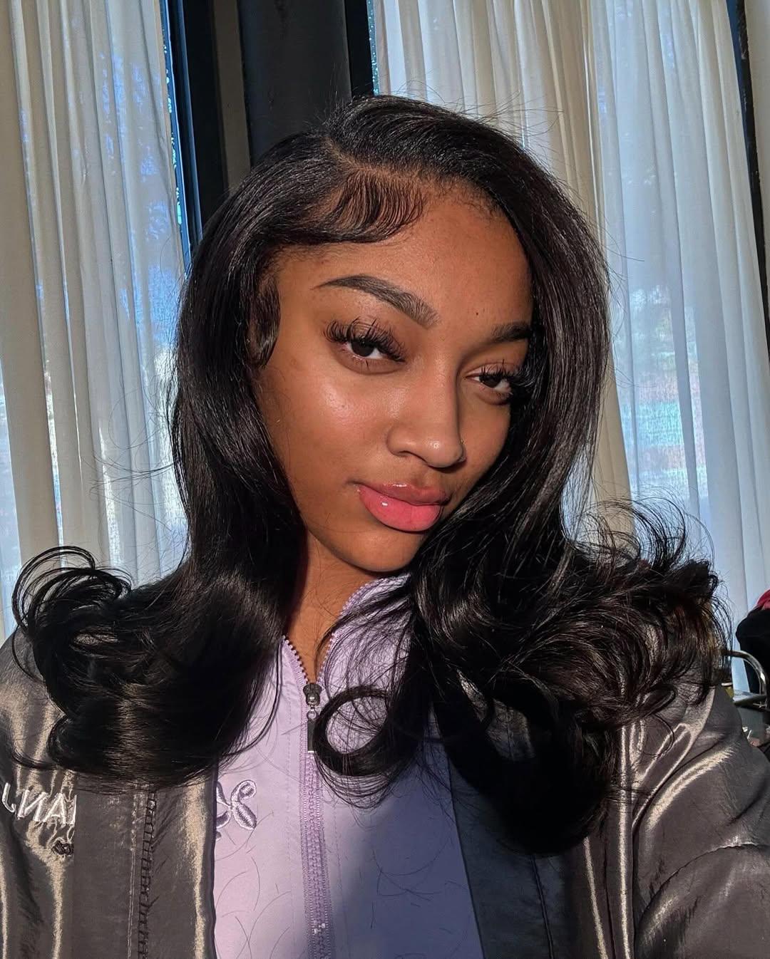 Angel Reese posing for a selfie.