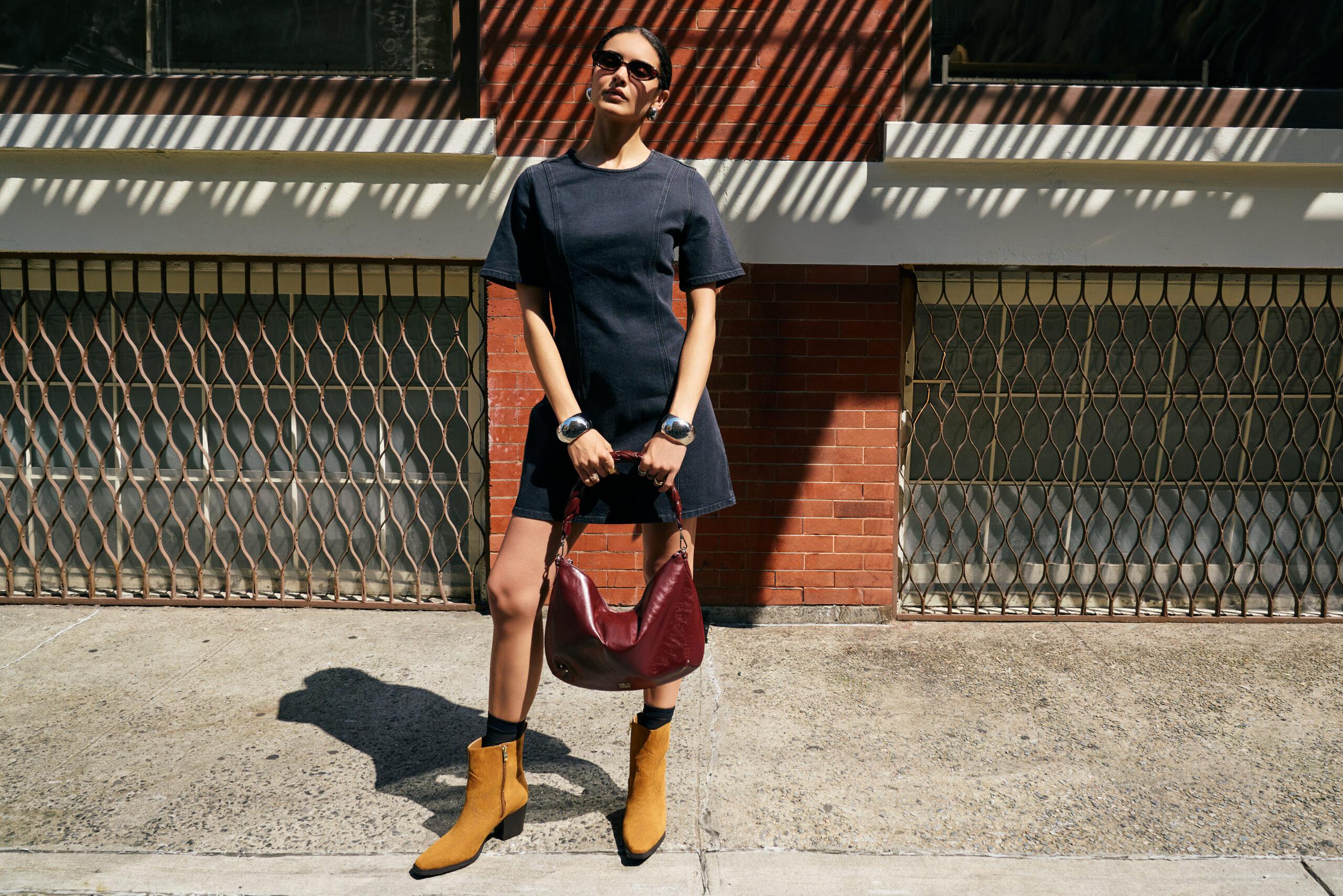 Woman holding RM Rebecca Minkoff bag