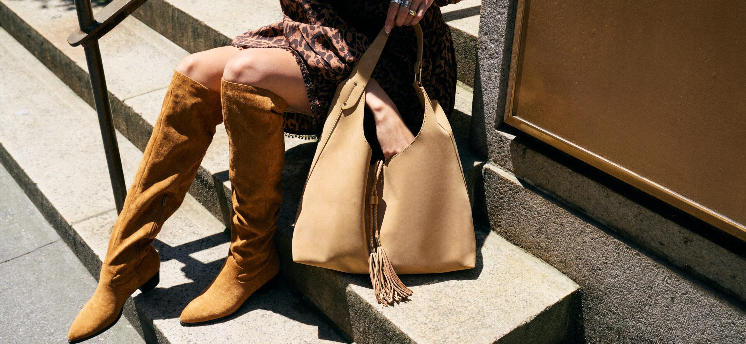 Woman holding RM Rebecca Minkoff bag