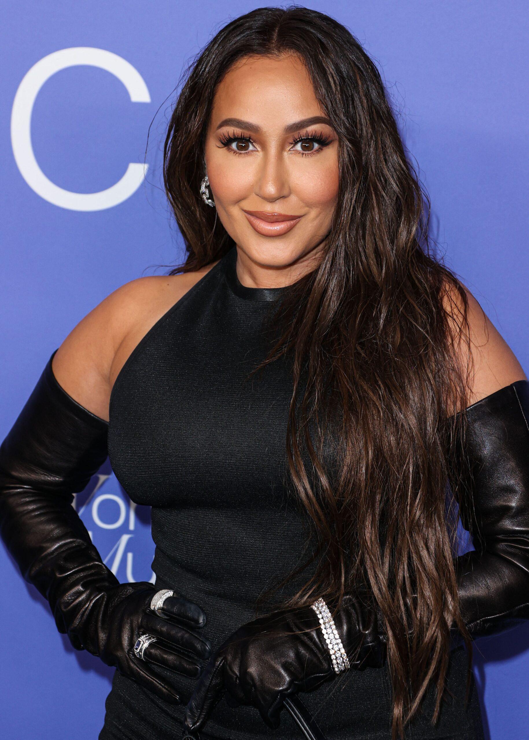 Adrienne Bailon-Houghton posing on the red carpet. 