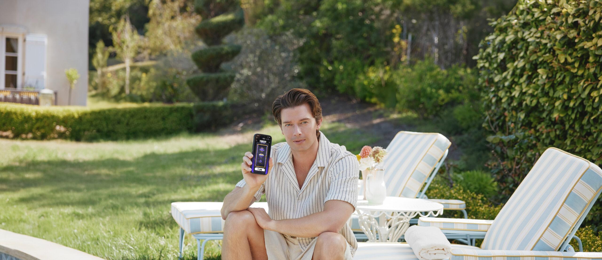 Patrick S posing with a phone. 