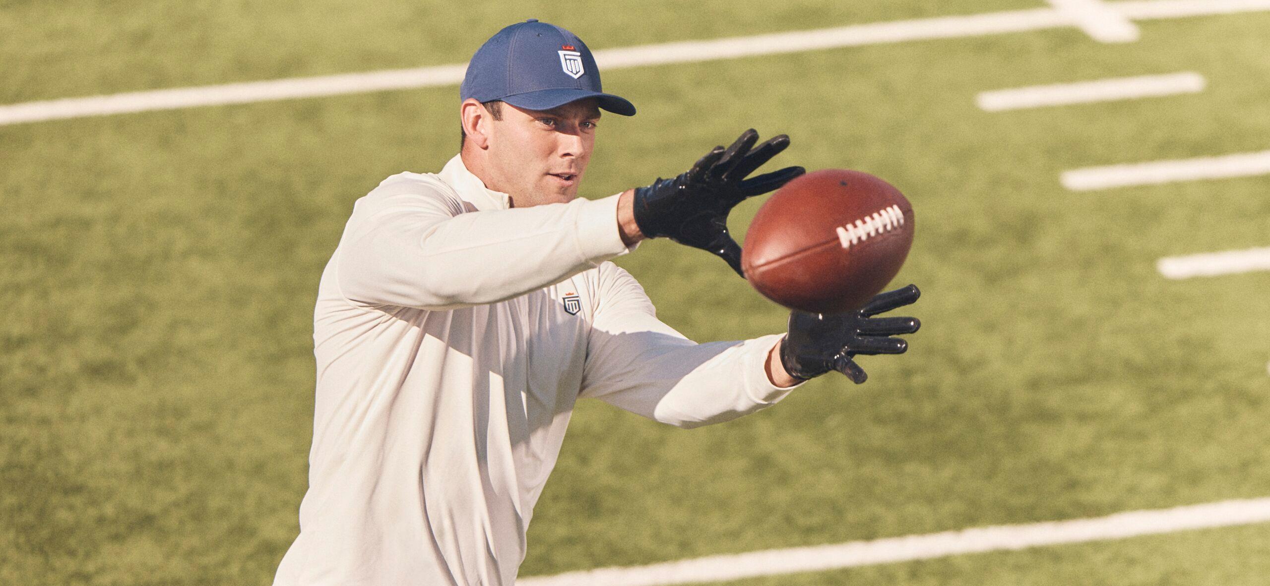Brock Bowers catching football for Greatness Wins campaign
