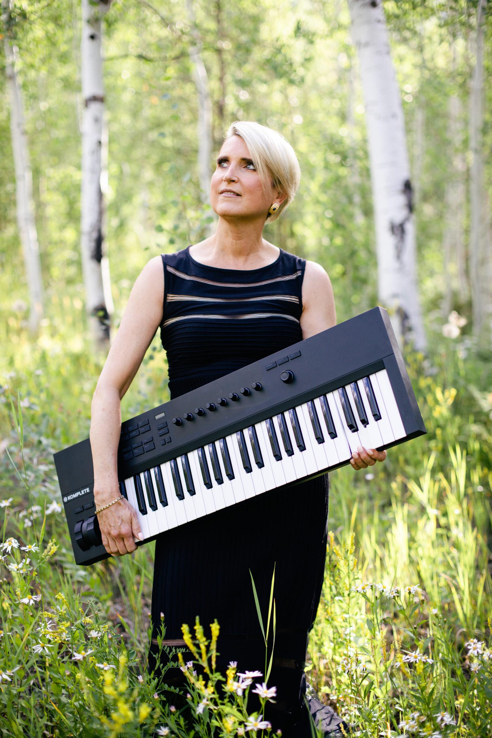 Anne-Marie Keane holding a keyboard