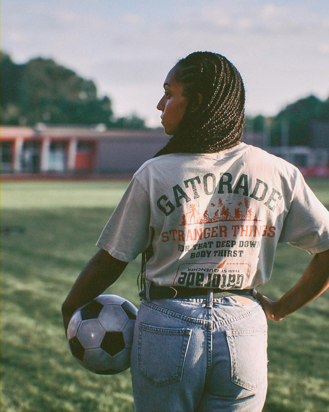 Woman wearing Gatorade and Stranger Things shirt