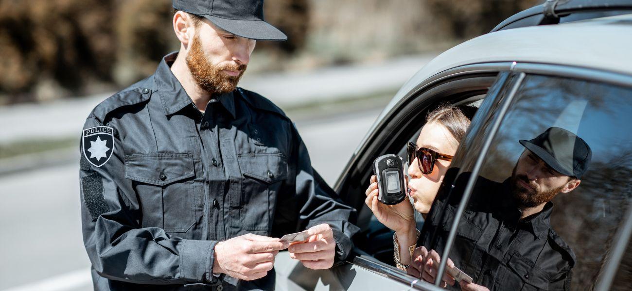 Police watching woman take breathalyzer