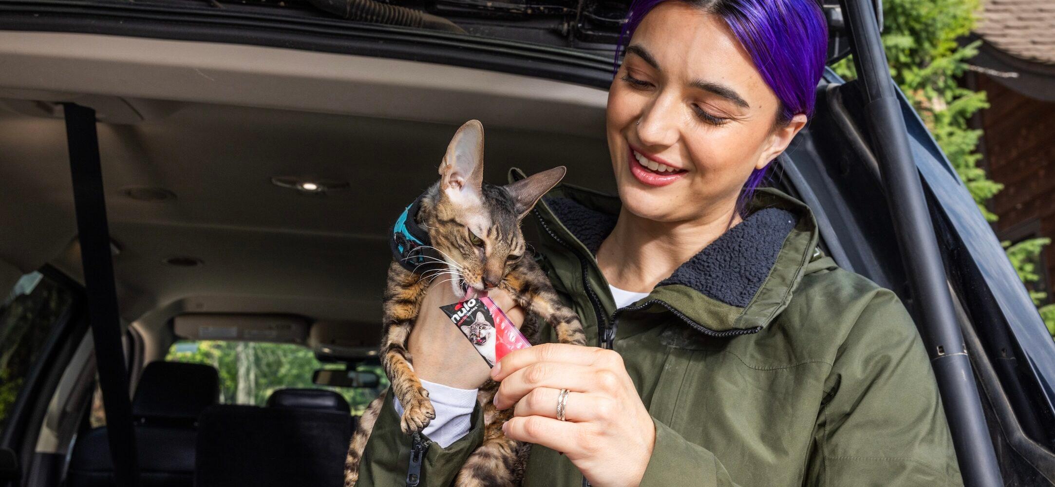 Brenna Huckaby feeding her cat