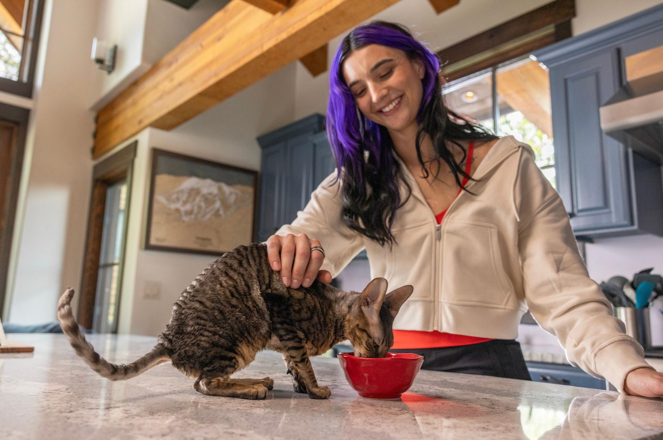 Brenna Huckaby feeding her cat