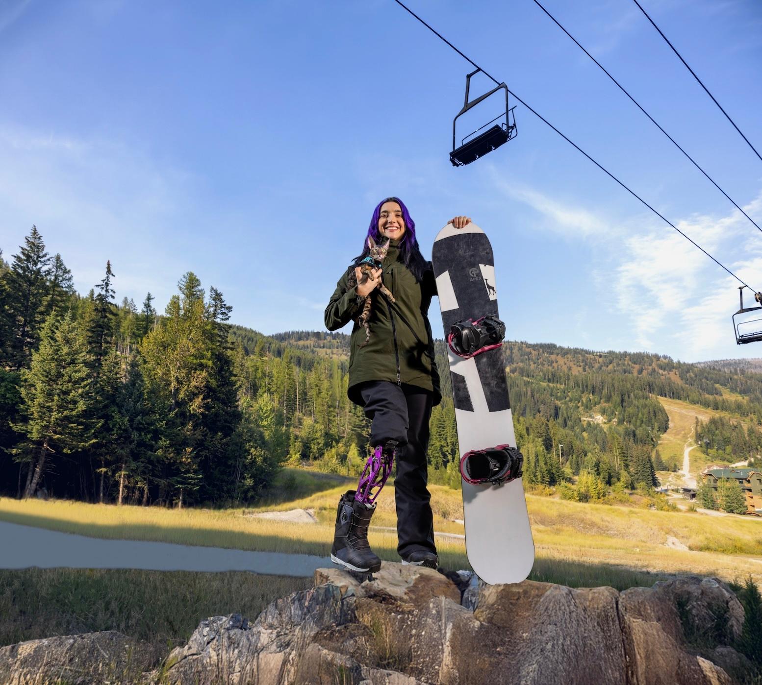 Brenna Huckaby and her cat with snowboard