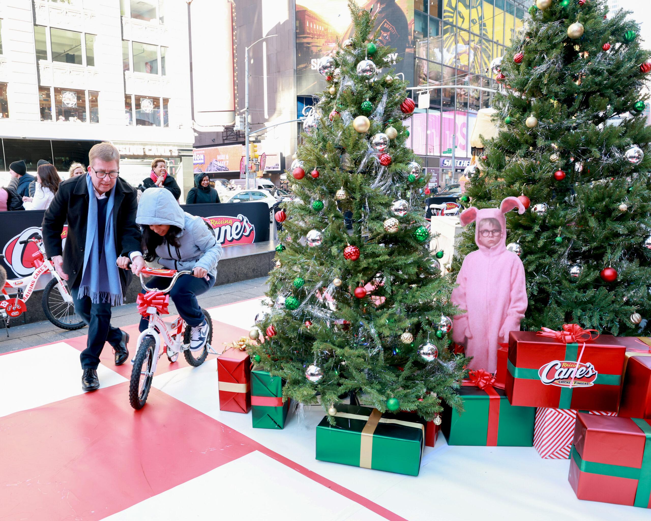 Peter Billingsley helping a kid ride a bike