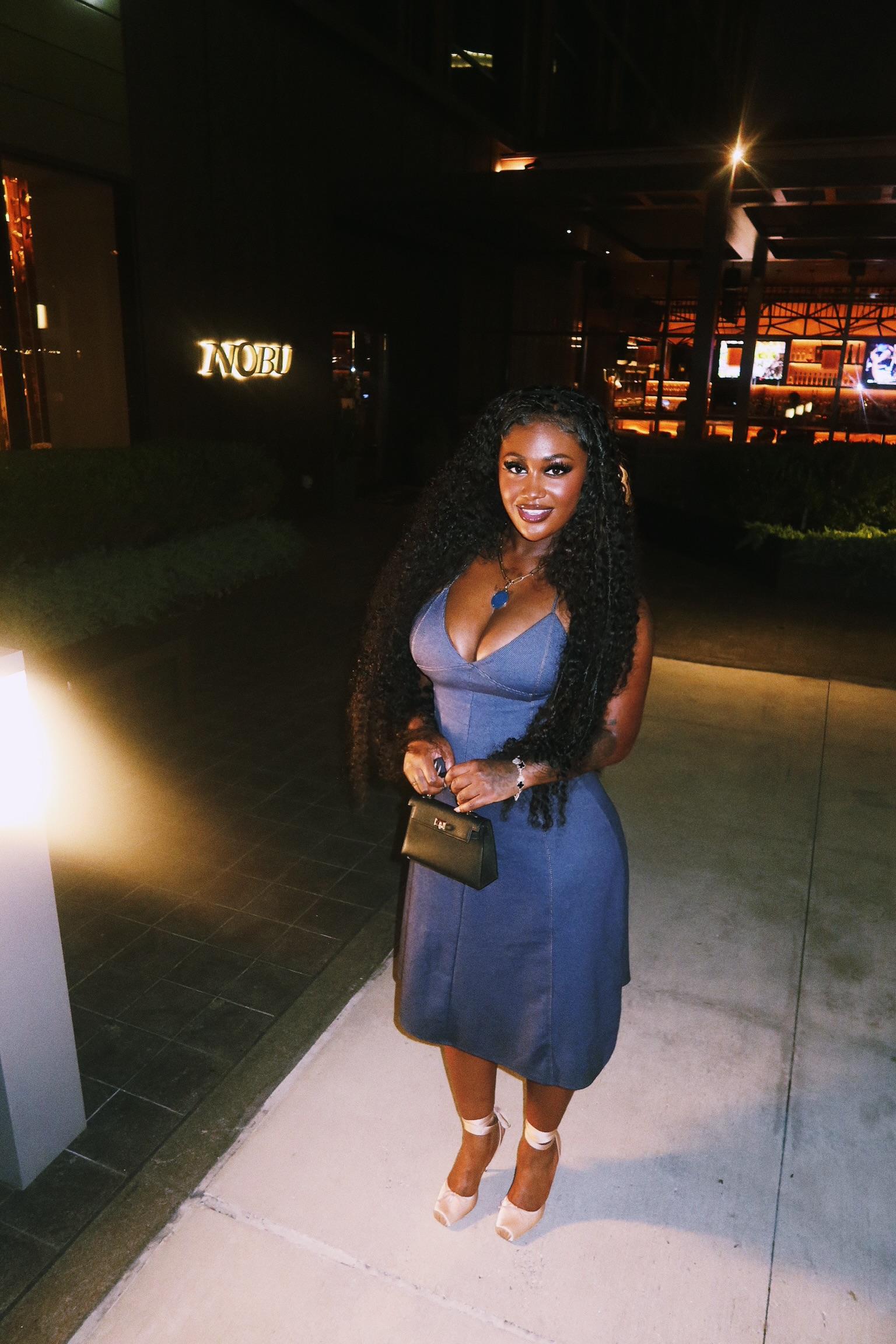 Kaliii holding a purse