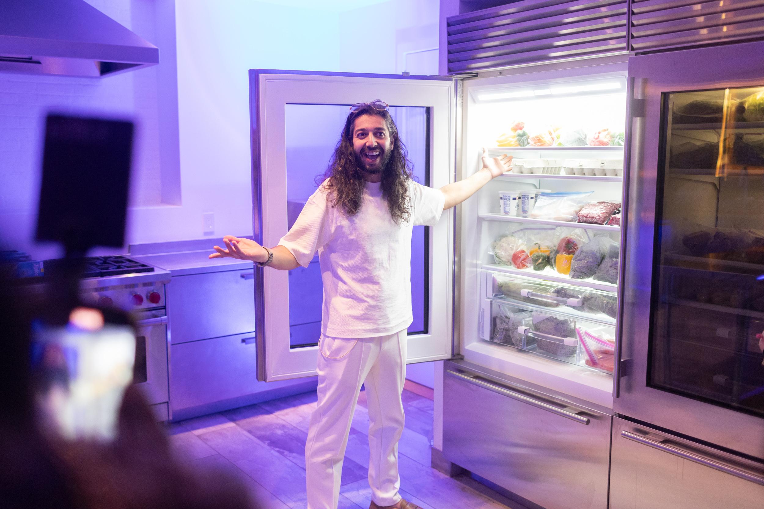 Armen Adamjan showing a fridge full of food