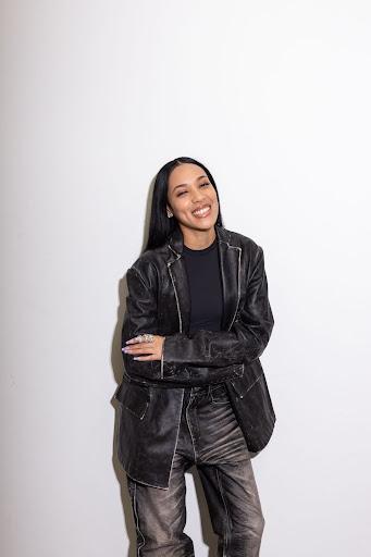 Aleali May posing in her jacket