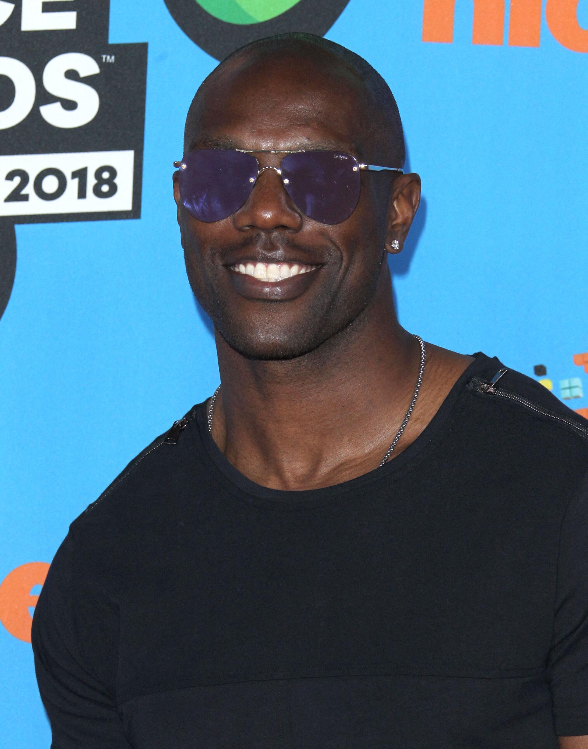 NFL star Terrell Owens posing on the red carpet. 