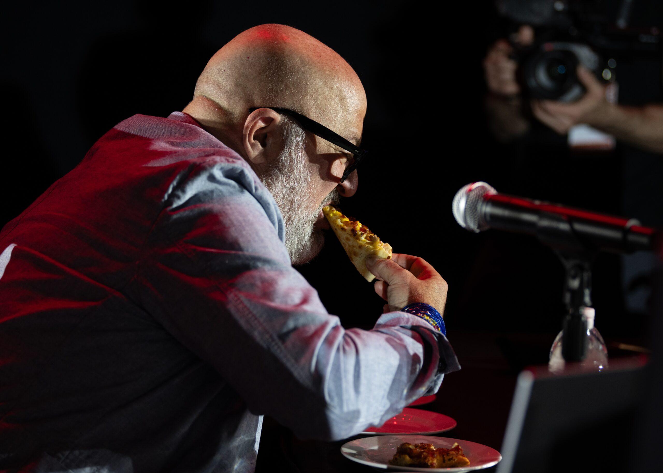 Andrew Zimmern eating Casey's pizza