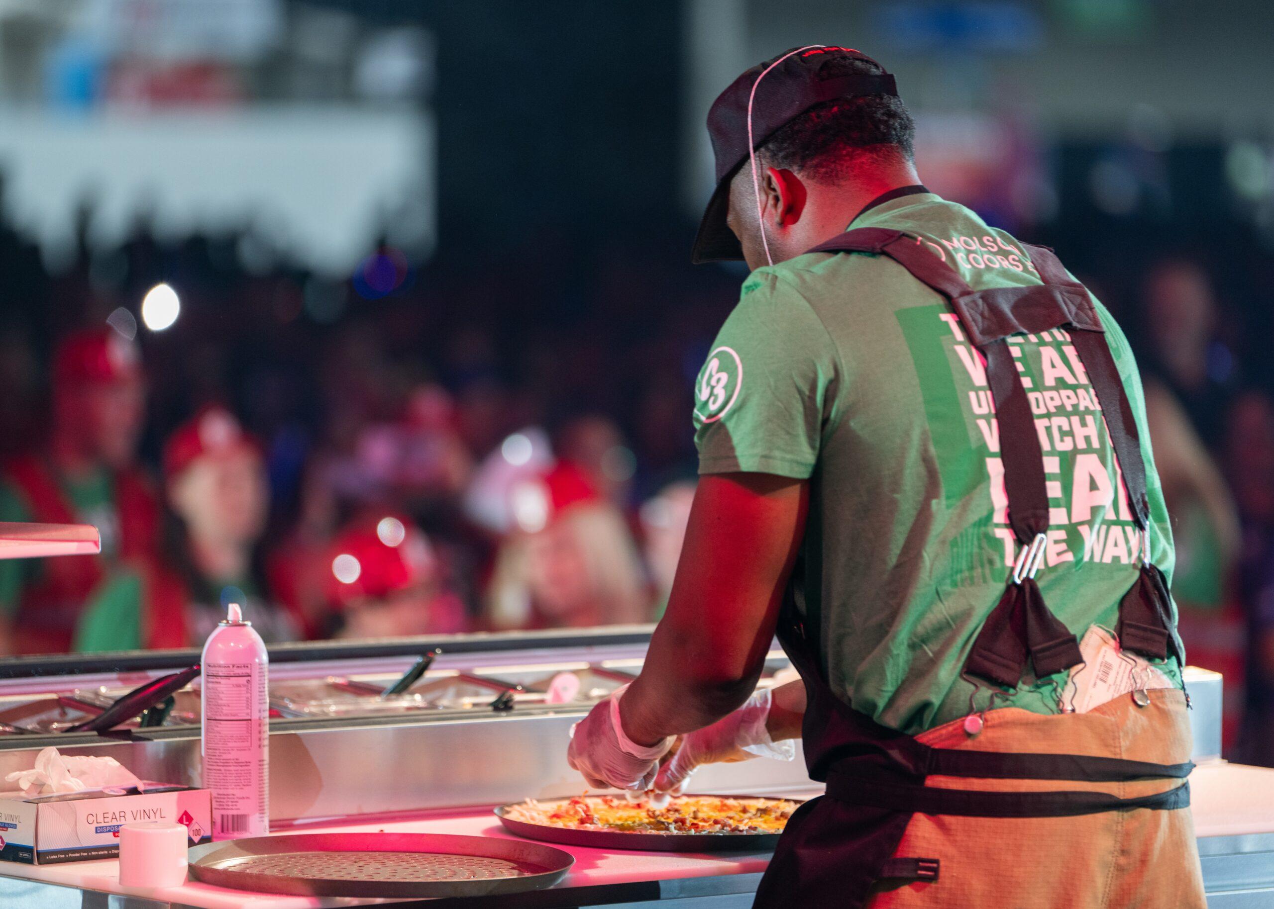 Man making the Barn Burner pizza